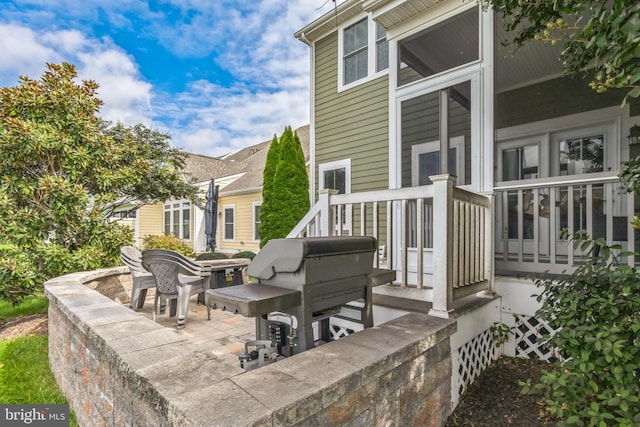 wooden terrace featuring a patio