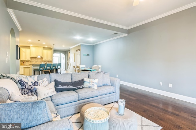 living room featuring ornamental molding and wood-type flooring