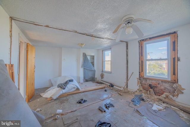 spare room featuring a textured ceiling and ceiling fan