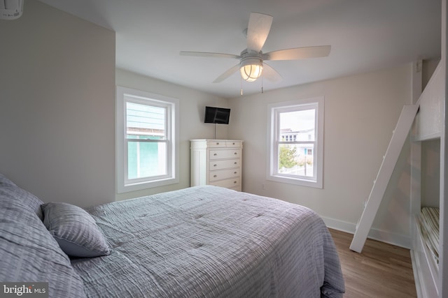 bedroom with hardwood / wood-style floors and ceiling fan