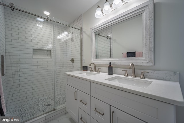 bathroom with vanity and a shower with door