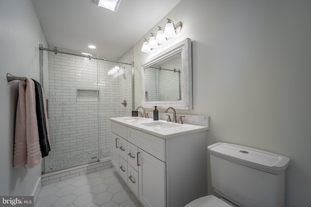 bathroom featuring vanity, toilet, tile patterned floors, and a shower with door