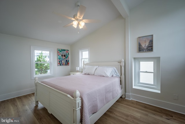 bedroom featuring ceiling fan, lofted ceiling, dark hardwood / wood-style floors, and multiple windows