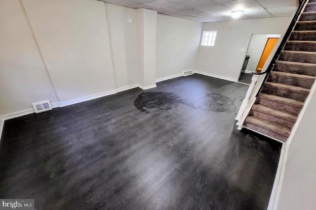 basement featuring a paneled ceiling