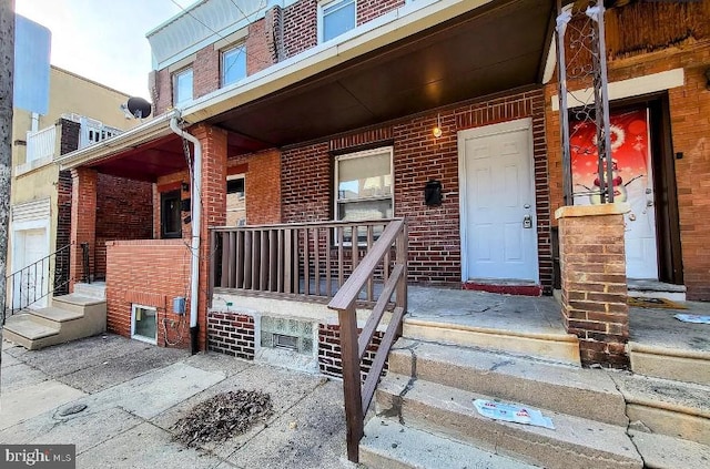 view of exterior entry with covered porch