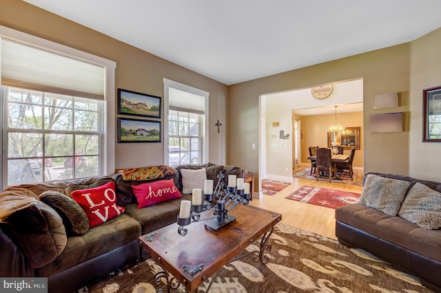 living room with hardwood / wood-style flooring and a notable chandelier