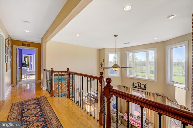 hallway with light hardwood / wood-style flooring