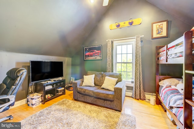 living room with baseboard heating, lofted ceiling, and hardwood / wood-style floors