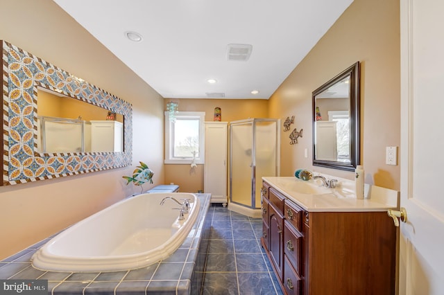 bathroom featuring vanity and shower with separate bathtub