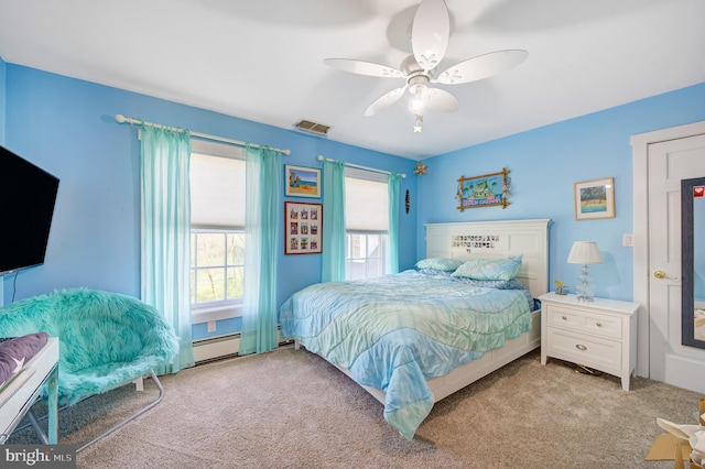 carpeted bedroom with ceiling fan and baseboard heating