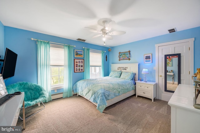 carpeted bedroom with ceiling fan and a baseboard radiator