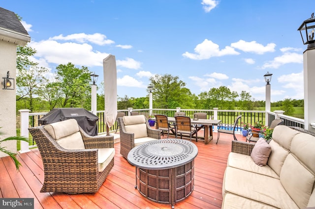 wooden terrace with an outdoor living space