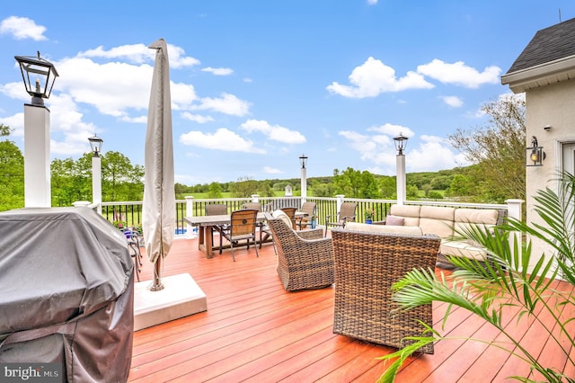 deck featuring an outdoor hangout area and a grill