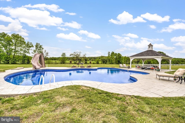 view of pool featuring a patio, a gazebo, a yard, and a water slide