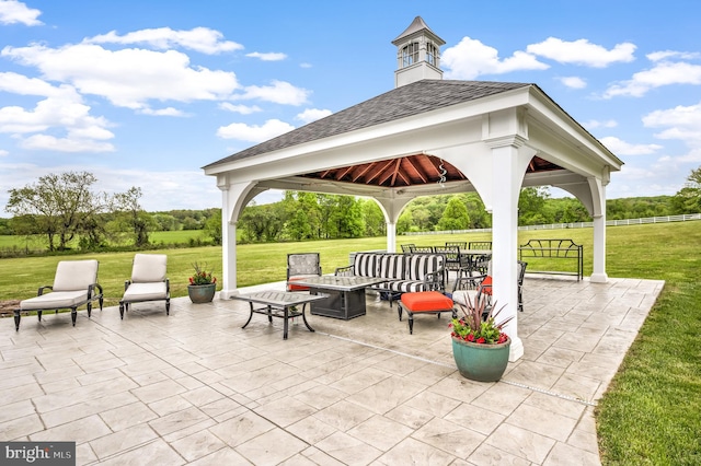 view of patio / terrace with a gazebo and a fire pit