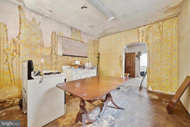 dining space featuring concrete flooring and washer / clothes dryer