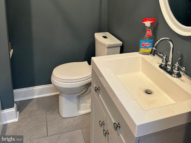 bathroom featuring tile patterned flooring, vanity, and toilet