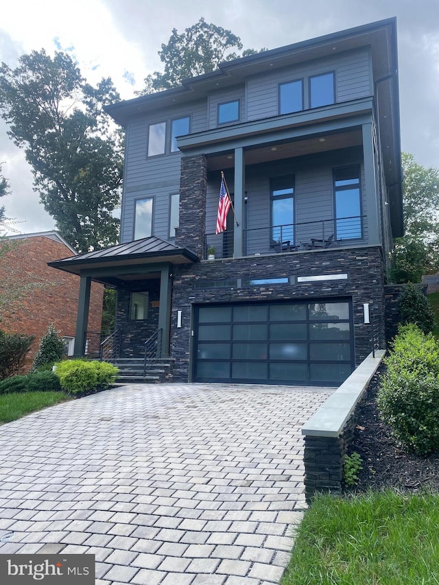 contemporary house featuring a garage and a porch