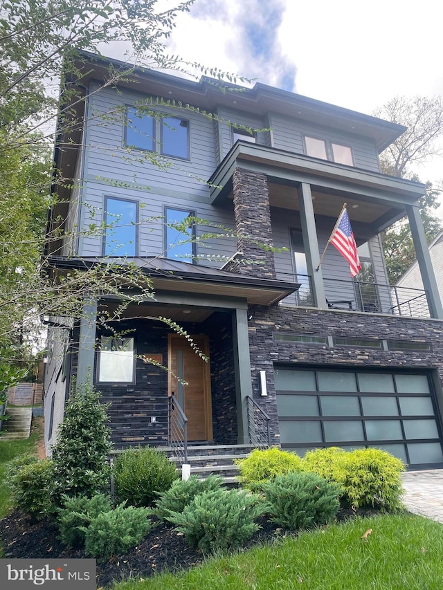 view of front facade with a garage and a porch