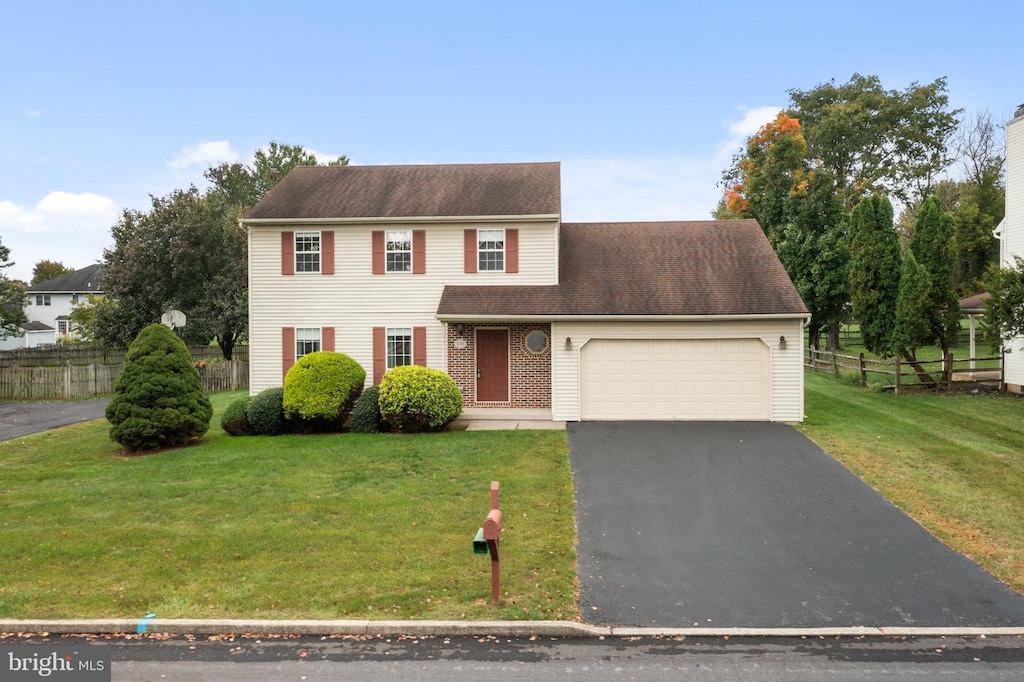 view of front facade with a garage and a front lawn