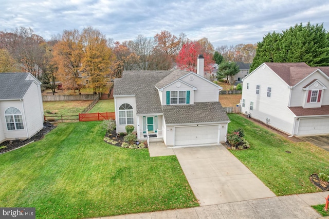 view of front of property featuring a front yard and a garage