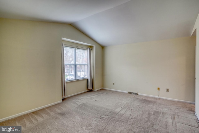 bonus room with light colored carpet and lofted ceiling