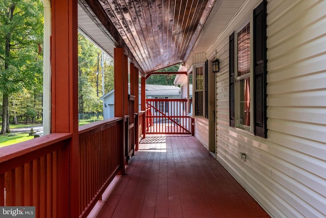 wooden terrace featuring covered porch