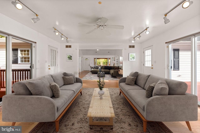 living room featuring ceiling fan and light wood-type flooring