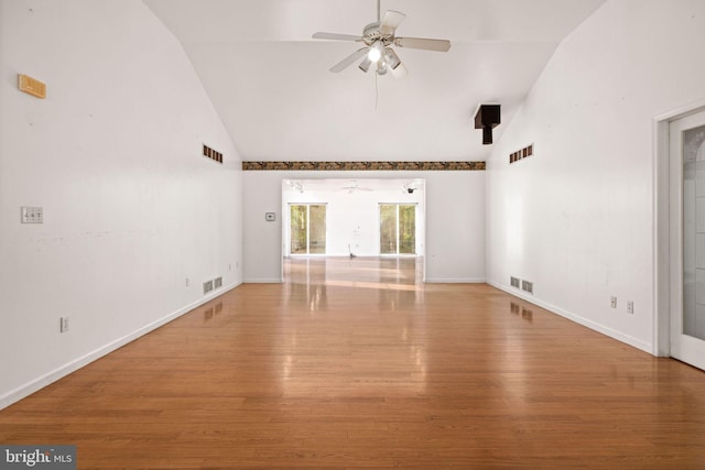 unfurnished room with wood-type flooring, ceiling fan, and high vaulted ceiling