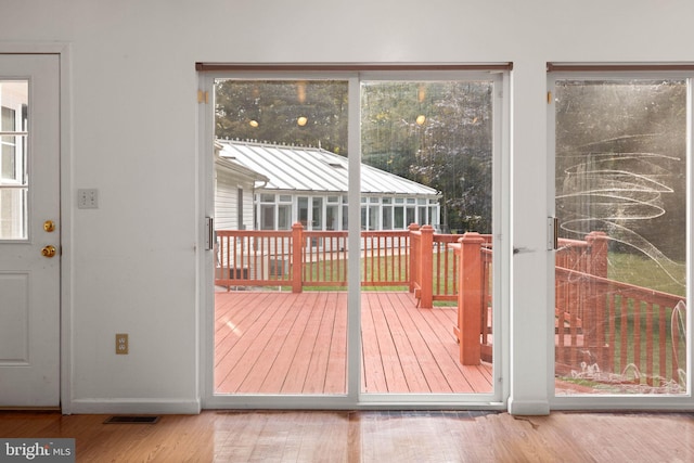 doorway featuring plenty of natural light and hardwood / wood-style flooring