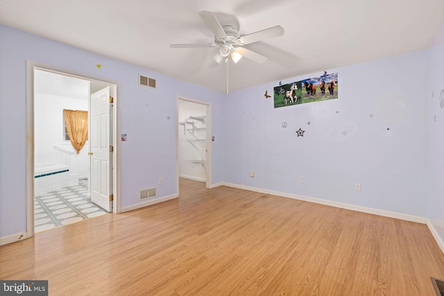 empty room featuring ceiling fan and light hardwood / wood-style flooring