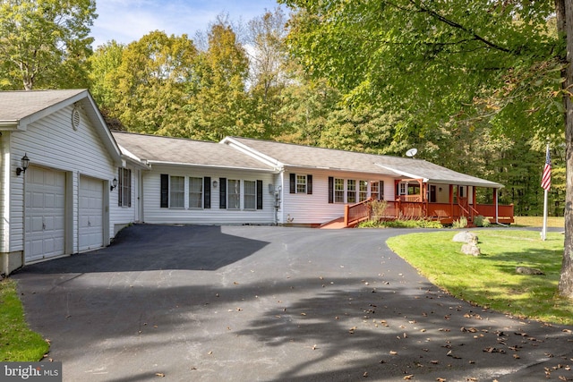 single story home with a garage and a front lawn