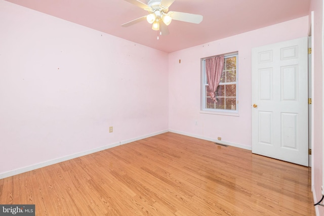 spare room featuring light hardwood / wood-style floors and ceiling fan