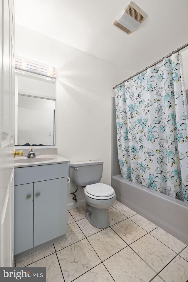 full bathroom with shower / tub combo, vanity, and toilet