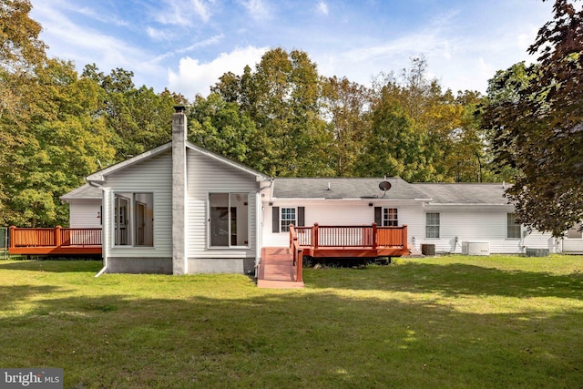 rear view of property with a lawn and a deck