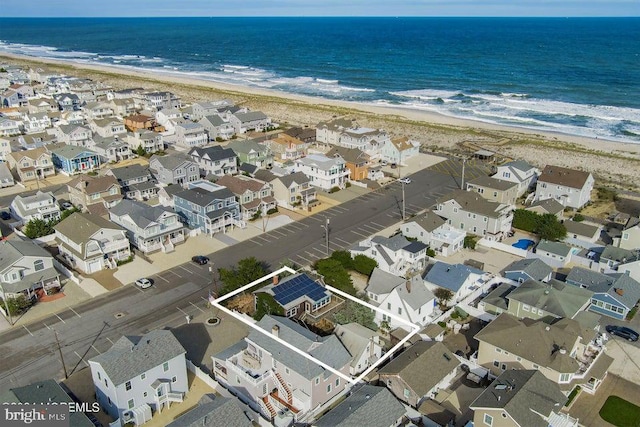 aerial view featuring a water view and a beach view