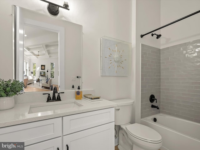 full bathroom featuring tiled shower / bath combo, vanity, beam ceiling, and toilet