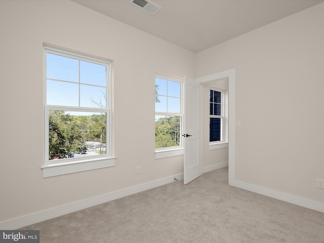 empty room featuring light colored carpet