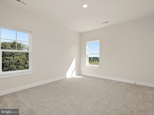 empty room with light colored carpet