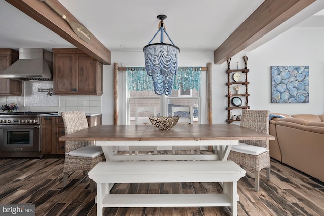 dining area featuring beam ceiling, dark hardwood / wood-style flooring, and a chandelier