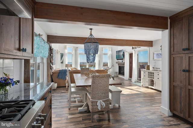 dining space with beamed ceiling and dark hardwood / wood-style floors