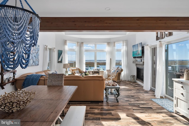 dining room with beam ceiling and hardwood / wood-style flooring