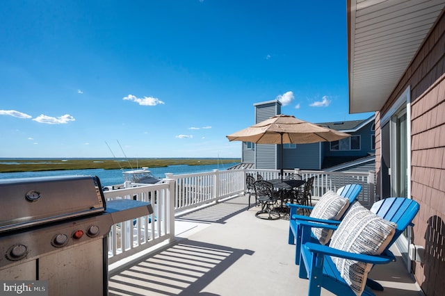 view of patio featuring a grill and a water view