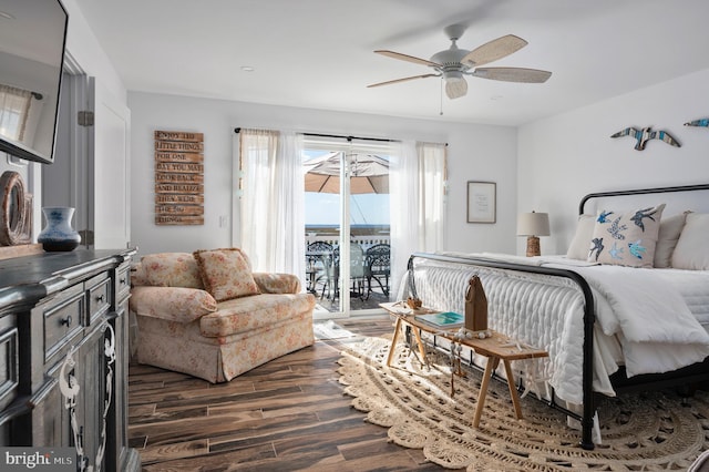 bedroom with access to exterior, dark wood-type flooring, and ceiling fan