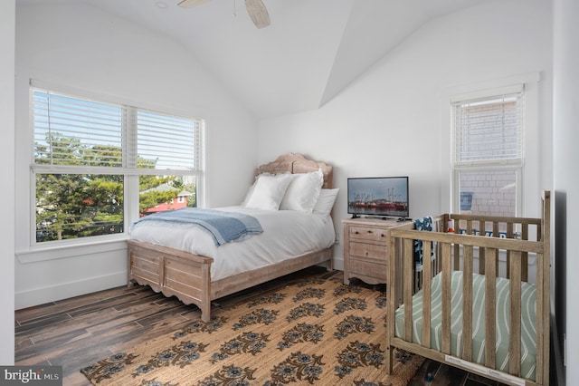 bedroom with ceiling fan, lofted ceiling, and dark hardwood / wood-style floors