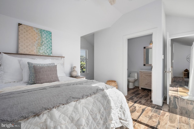 bedroom with connected bathroom, hardwood / wood-style flooring, and lofted ceiling