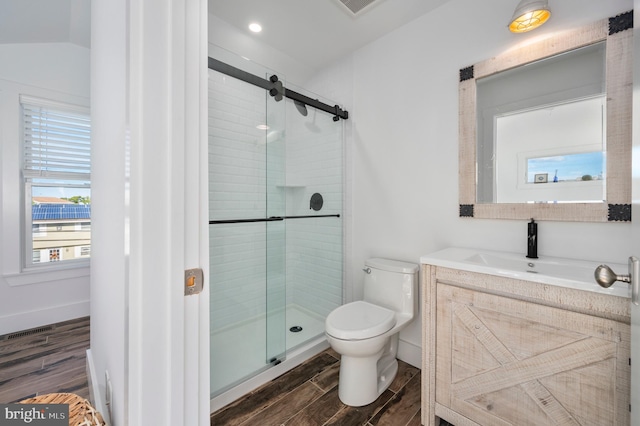 bathroom with vanity, toilet, hardwood / wood-style flooring, and an enclosed shower