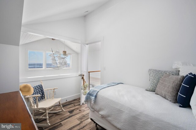 bedroom with hardwood / wood-style floors and vaulted ceiling with beams