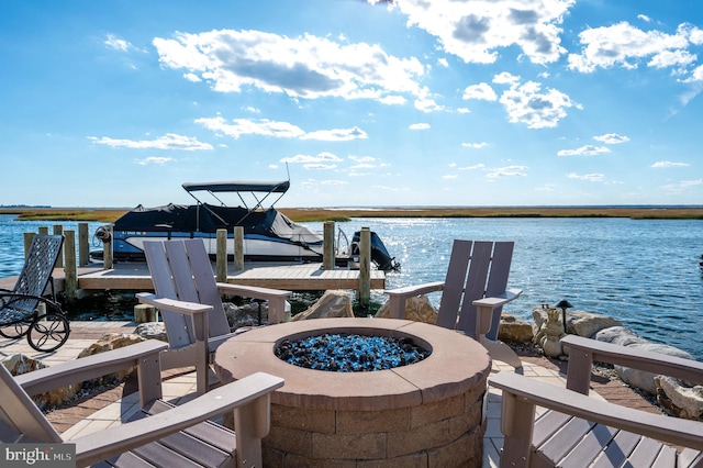 dock area with a water view and an outdoor fire pit