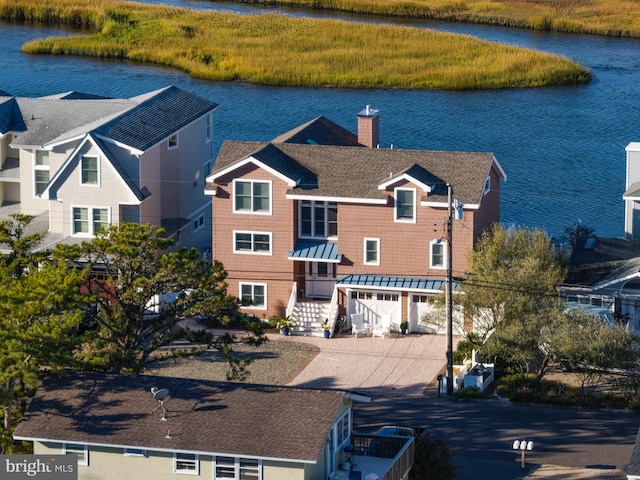 view of front facade featuring a garage and a water view